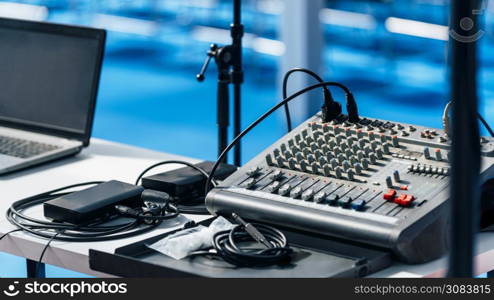 Laptop computer and audio sound mixer in the empty press conference hall.