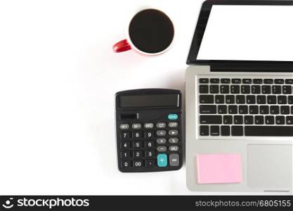 laptop computer, calculator and coffee cup on white background - top view