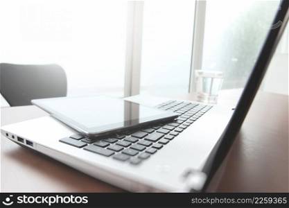 laptop computer on office table with pen and digital tablet as work space business concept