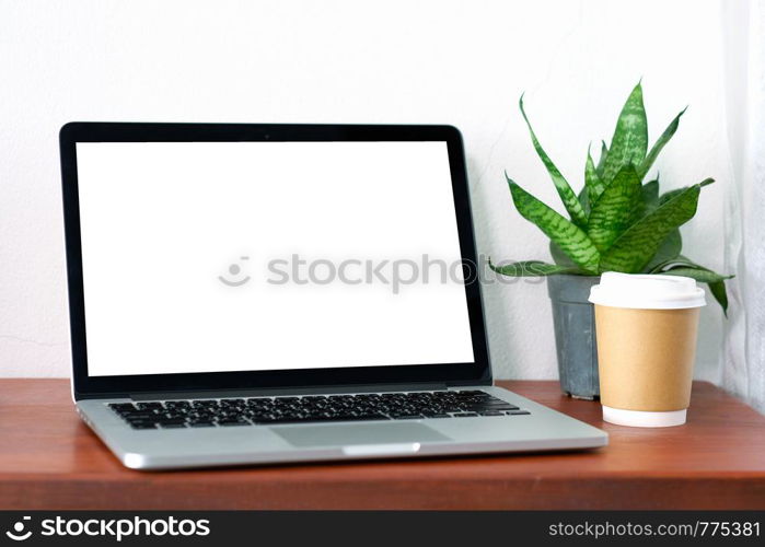 Laptop computer with blank screen and coffee cup on wood table background, mock up display, business and technology, online education, technology lifestyle concept