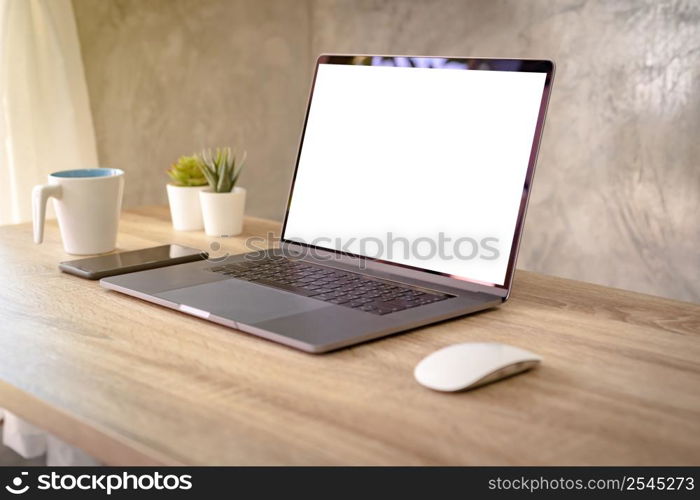 Laptop computer with blank screen on table.