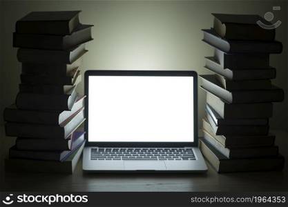 laptop dark stacked books. High resolution photo. laptop dark stacked books. High quality photo