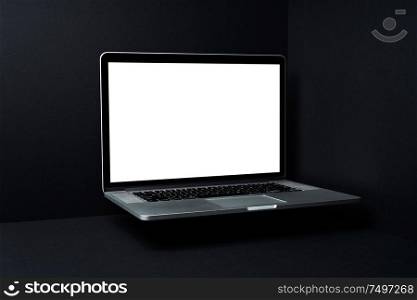 Laptop floating with white blank screen on mockup three dimensional black background