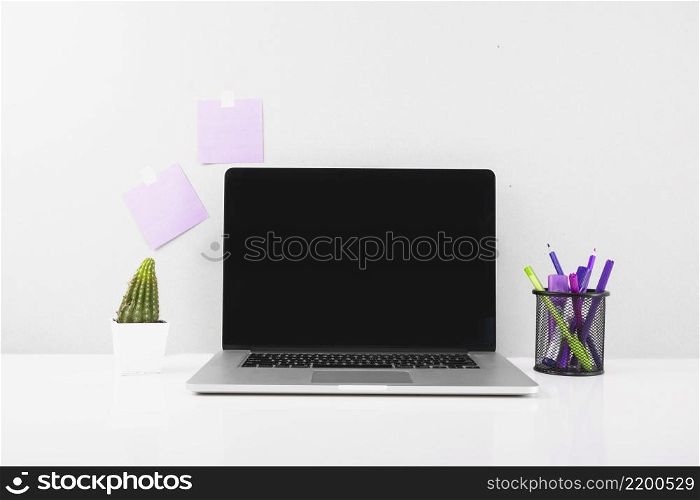 laptop front adhesive notes stucked wall