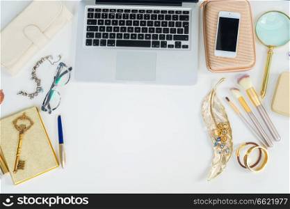 Laptop keyboard with golden woman accessories mock up flat lay scene, top view, copy space on white table background. Offise desktop scene