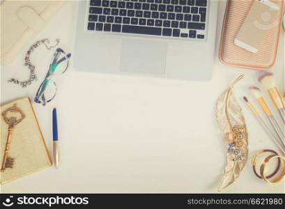 Laptop keyboard with golden woman accessories mock up flat lay styled scene, top view, copy space on white table background, retro toned. Offise desktop scene