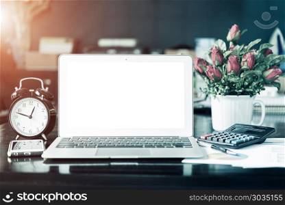 Laptop, mobile phone and office accessories in business office. . Laptop, mobile phone and office accessories in business office. Business background. Vintage filtered.