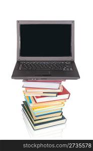laptop on pile of books