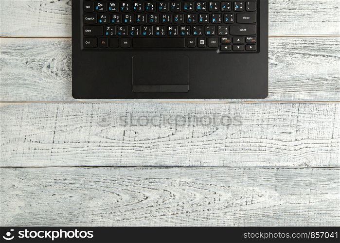 laptop on vintage shabby white wooden background. the view from the top. flat lay