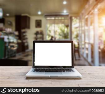 Laptop on wood table in coffee shop