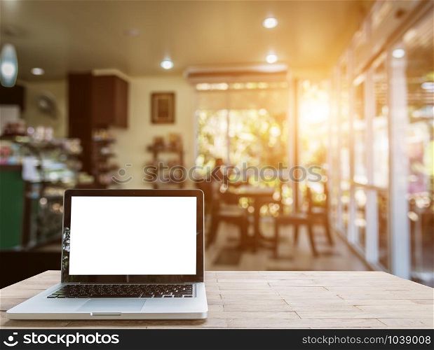 Laptop on wood table in coffee shop