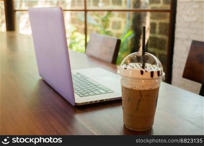 Laptop On Wooden Table At Coffee Shop, stock photo