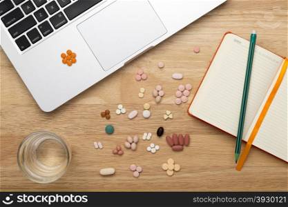 Laptop pc and colorfull pills. Laptop pc and medicine pills and drink