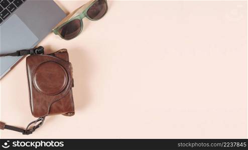 laptop sunglasses camera its case plain colored background
