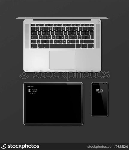 Laptop, tablet and phone set mockup isolated on black background with blank screens. 3D render. Laptop, tablet and phone set mockup isolated on black. 3D render