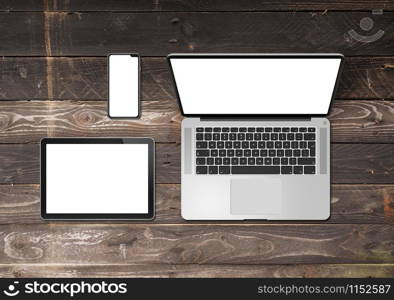 Laptop, tablet and phone set mockup on a wooden desk background. 3D render. Laptop, tablet and phone set mockup on a wooden background. 3D render