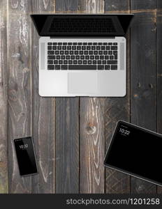 Laptop, tablet and phone set mockup on a wooden desk background. 3D render. Laptop, tablet and phone set mockup on a wooden background. 3D render