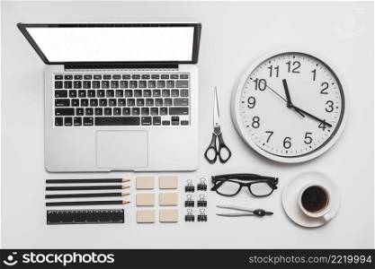 laptop wall clock cup coffee office stationery white backdrop