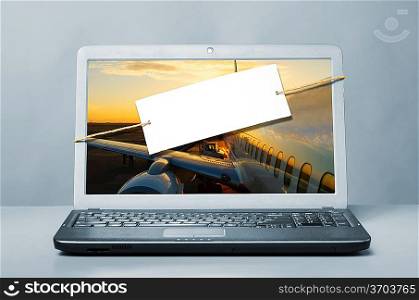 laptop with blank note on blue background
