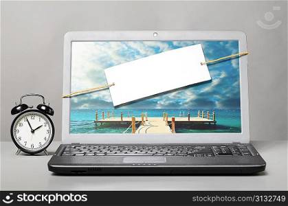 laptop with blank note on gray background