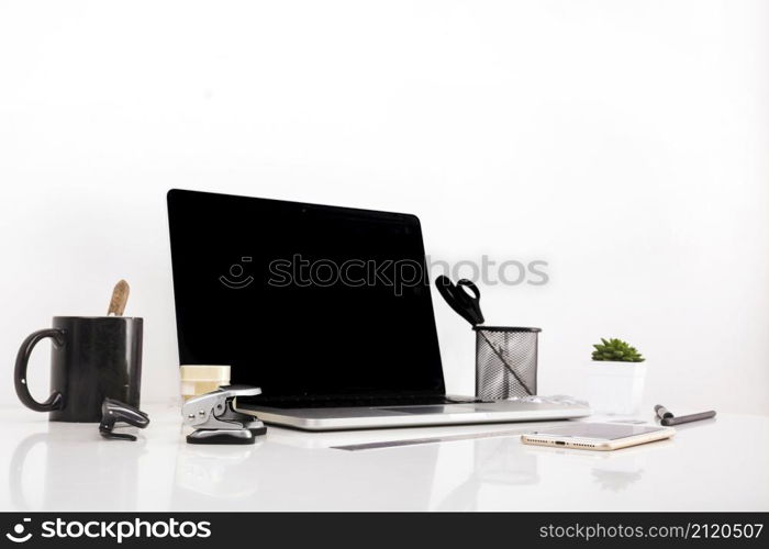 laptop with blank screen cellphone reflective desk