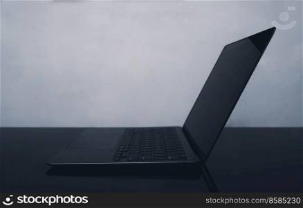 Laptop with blank screen closeup concept image. Side view photo of notebook computer with black display. Portable electronic device. Picture for web banner, landing page, blog, news and article. Laptop with blank screen closeup concept image