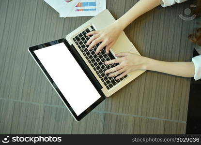 laptop with blank screen on desk in meeting room, mock up