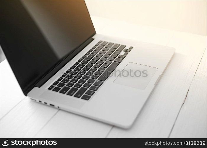 Laptop with blank screen on table. 