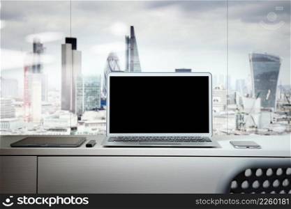 Laptop with blank screen on white desk with blurred background as concept