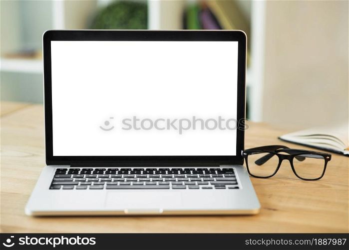 laptop with blank white screen eyeglasses wooden desk . Resolution and high quality beautiful photo. laptop with blank white screen eyeglasses wooden desk . High quality and resolution beautiful photo concept