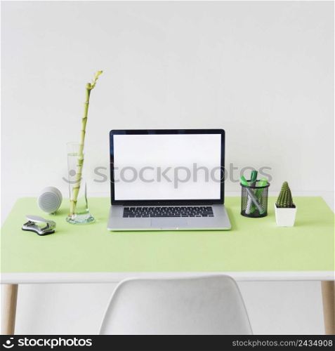 laptop with blank white screen office desk