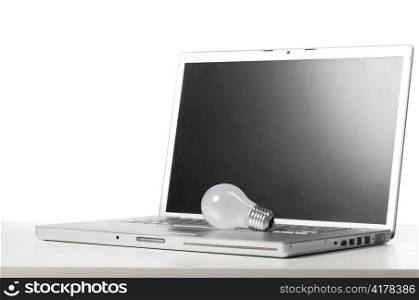 laptop with bulb on table cut out