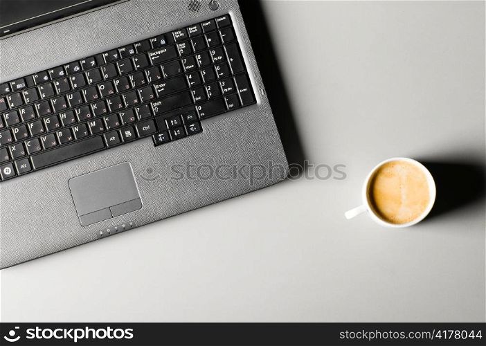 laptop with cup of coffee, view from above