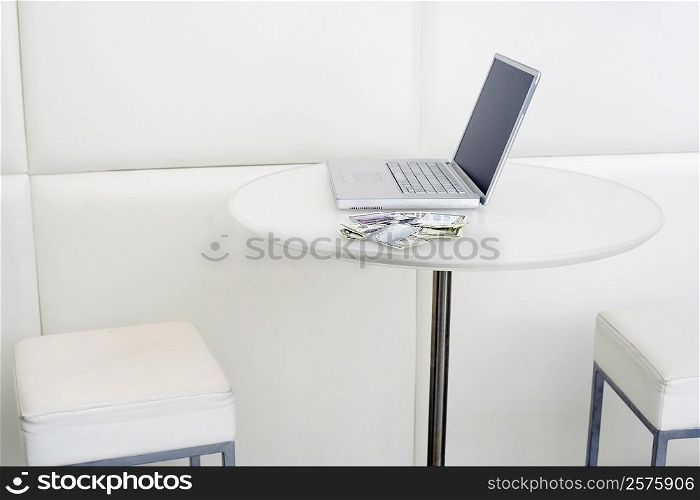 Laptop with dollar bill on the table