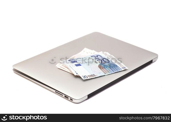 Laptop With Euro money isolated on white