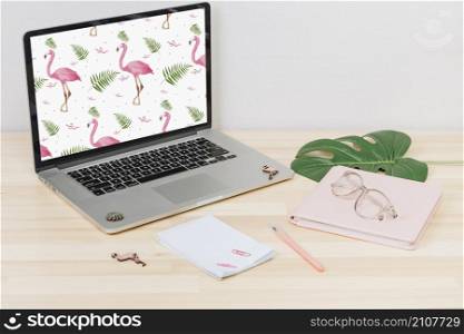 laptop with flamingos screen table