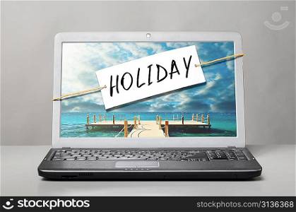 laptop with holiday note