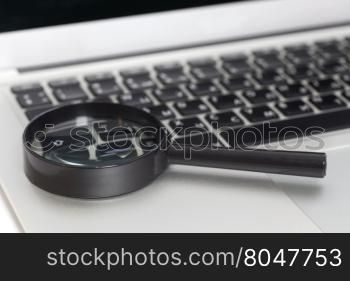 Laptop With Magnifying Glass.Close up
