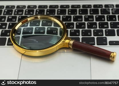 Laptop With Magnifying Glass close up