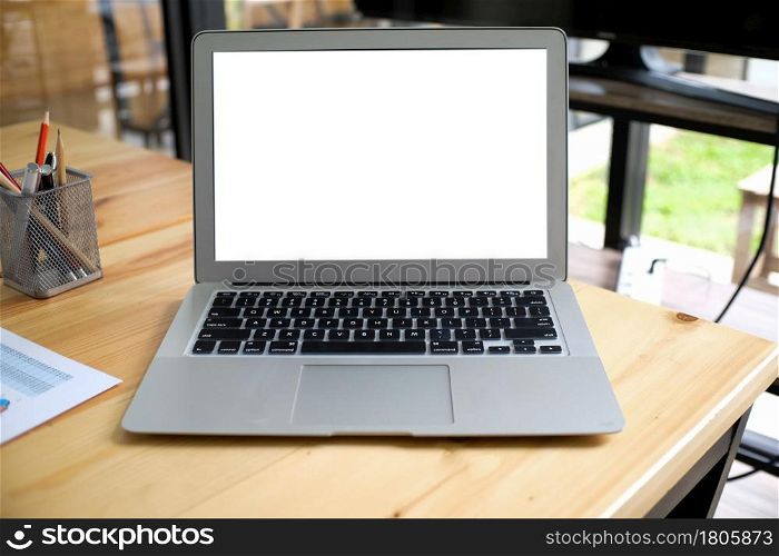 Laptop with Mock up blank screen on wooden table in front of cafe space for text. product display computer laptop montage- technology Freelance work concept