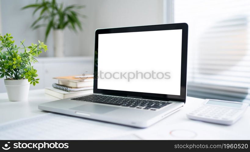 Laptop with Mock up blank screen on wooden table in front of cafe space for text. product display computer laptop montage- technology Freelance work