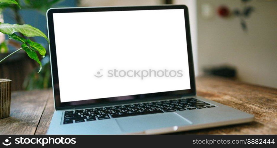 Laptop with Mock up blank screen on wooden table in front of cafe space for text. product display computer laptop montage- technology Freelance work concept