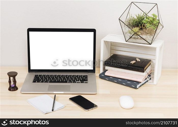 laptop with notebooks wooden table