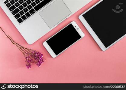 laptop with tablet smartphone pink table
