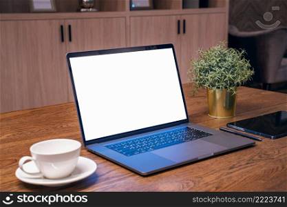 Laptop with white screen on the table. Work from home.