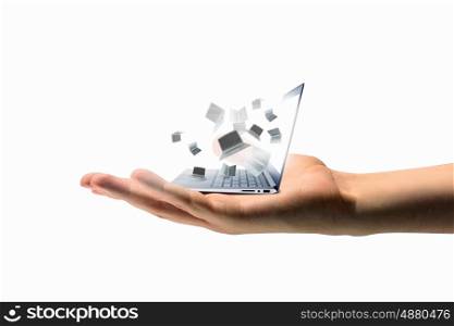 Laptops in hand. Pile of laptops in human hand. Technology concept