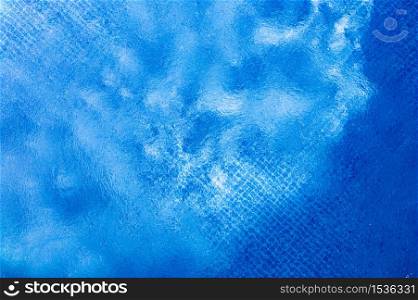 Large above ground metal frame swimming pool top view of water surface. Summer theme. Large above ground metal frame swimming pool top view of water surface