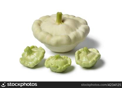 Large and baby Pattypan squashes on white background