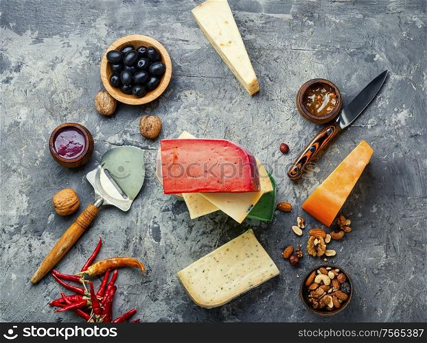 Large assortment of international cheese on slate background.Cheese variety. Different kinds of cheeses
