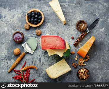Large assortment of international cheese on slate background.Cheese variety. Different kinds of cheeses